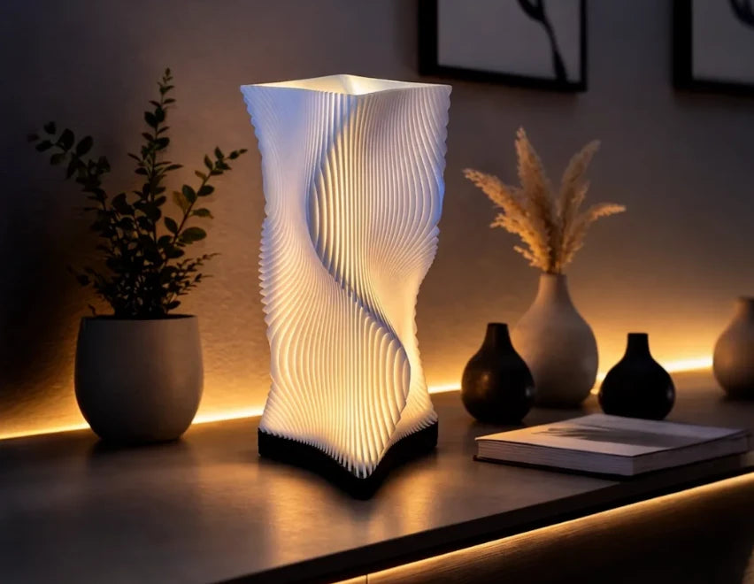 Luméa Helix table lamp with a black base, lit on a shelf
